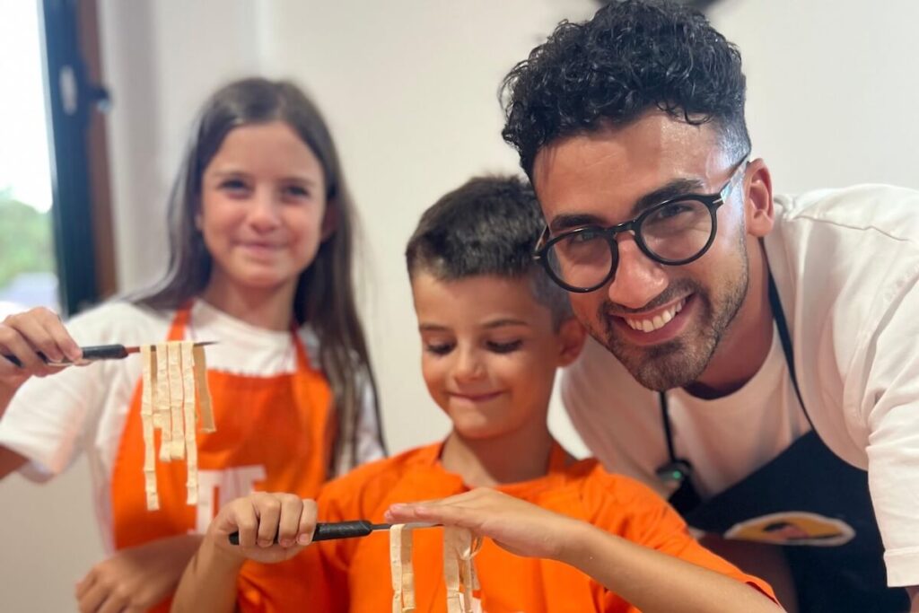 Kids making pasta in a cooking class